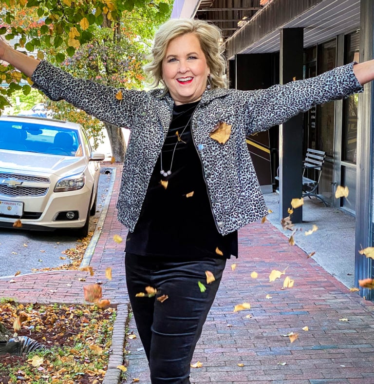 Fashion Blogger 50 Is Not Old is Holiday festive in a black velvet tank top and jeggings, and an animal print jacket from Chico's