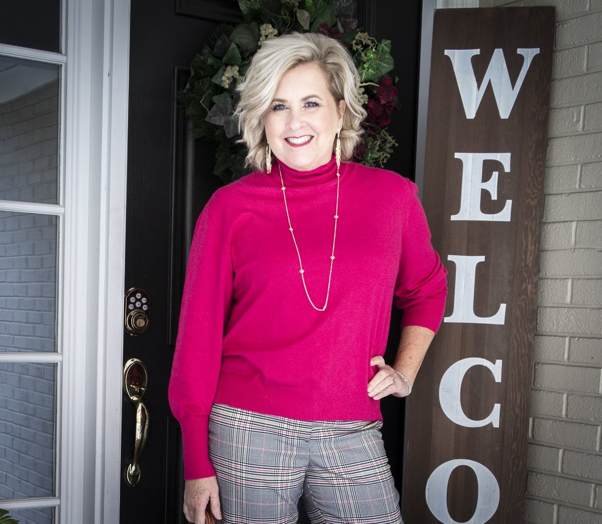 Fashion Blogger 50 Is Not Old is wearing a bright pink sweater from Walmart