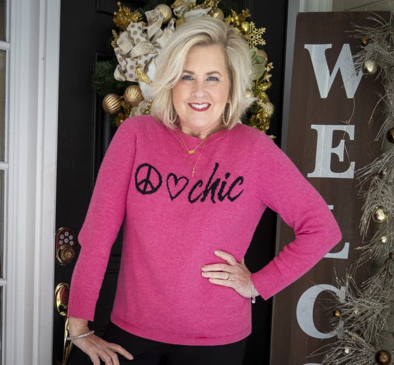 Fashion Blogger 50 Is Not Old is wearing a bright pink Chic sweater
