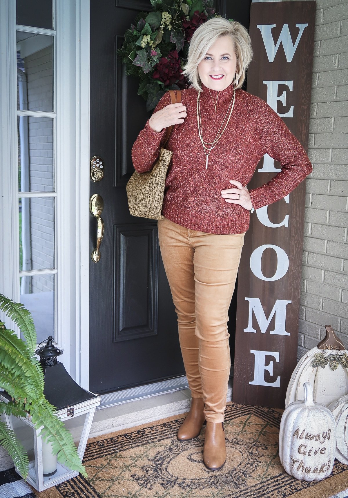 Fashion Blogger 50 Is Not Old is wearing a gorgeous rust turtleneck sweater with caramel colored corduroy skinny pants and caramel colored ankle boots