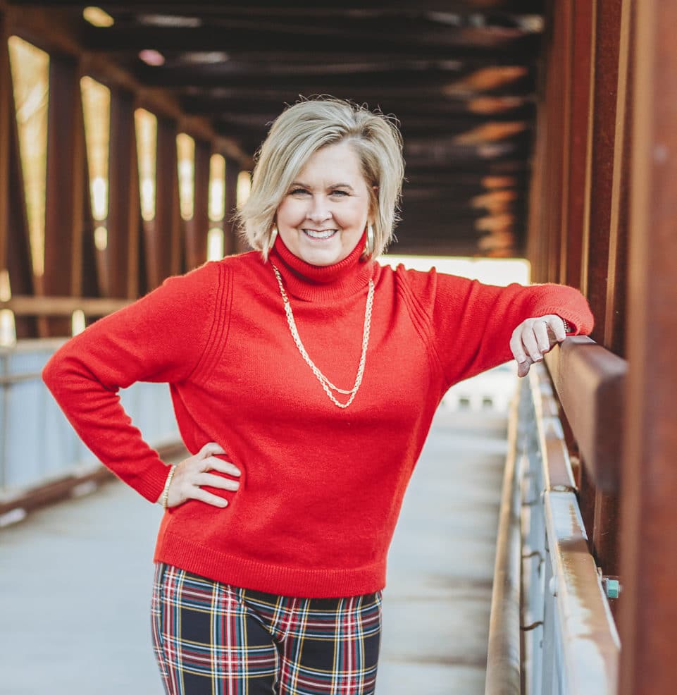Fashion Blogger 50 Is Not Old is looking festive in this red turtleneck sweater and gold jewelry from Kendra Scott