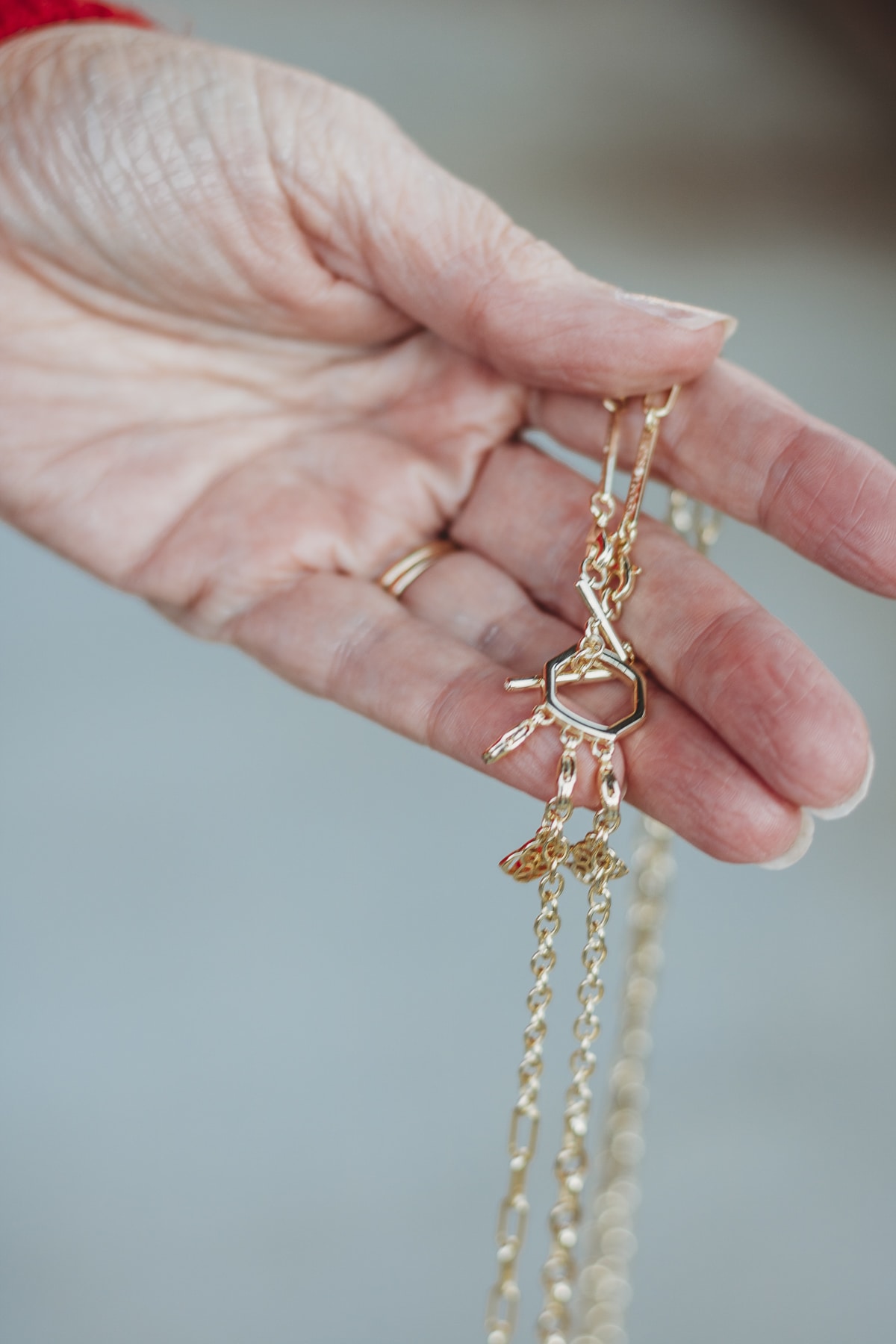 Fashion Blogger 50 Is Not Old is showing a piece of jewelry from Kendra Scott