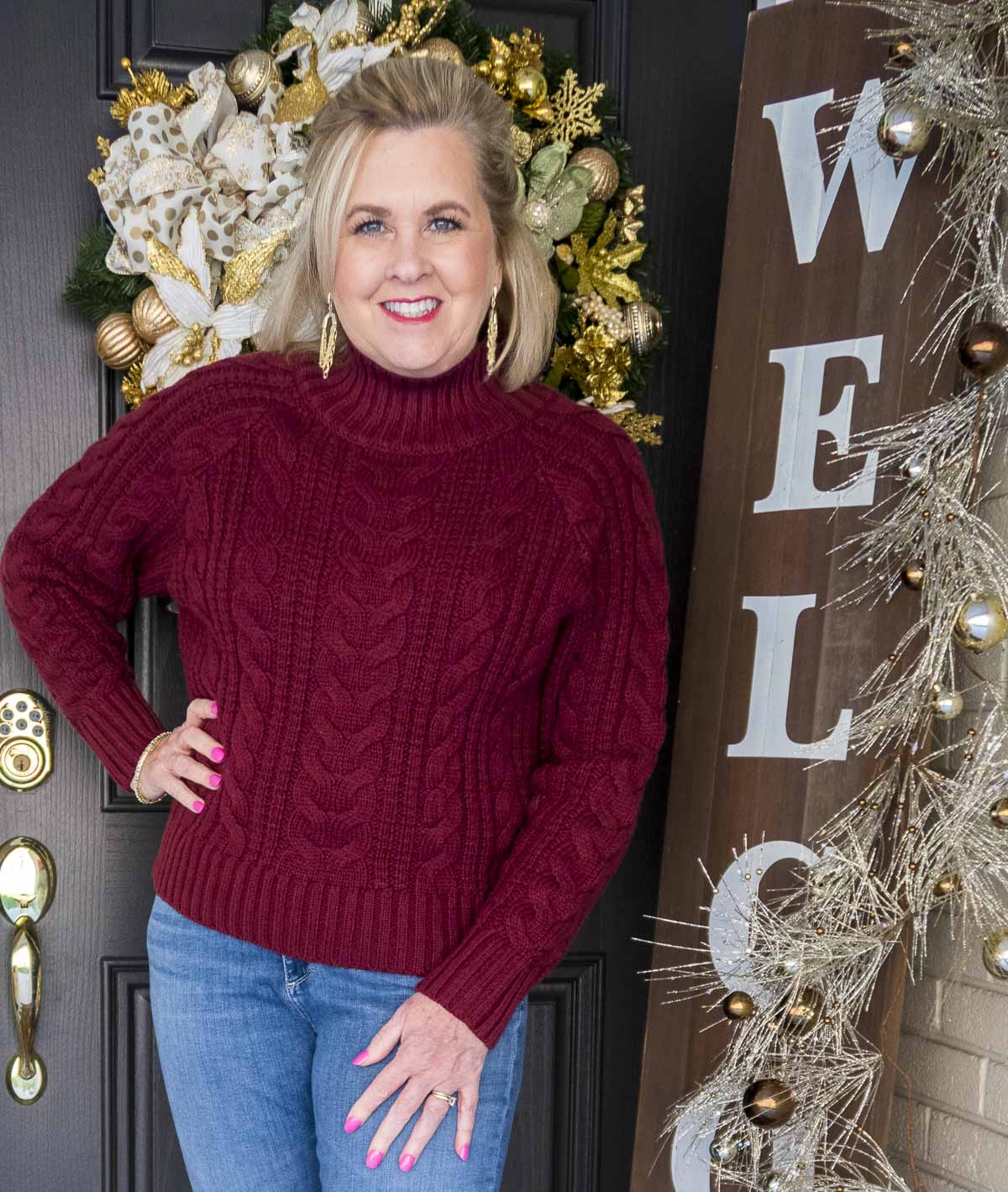 Fashion Blogger 50 Is Not Old is styling a cranberry cable-knit turtleneck sweater