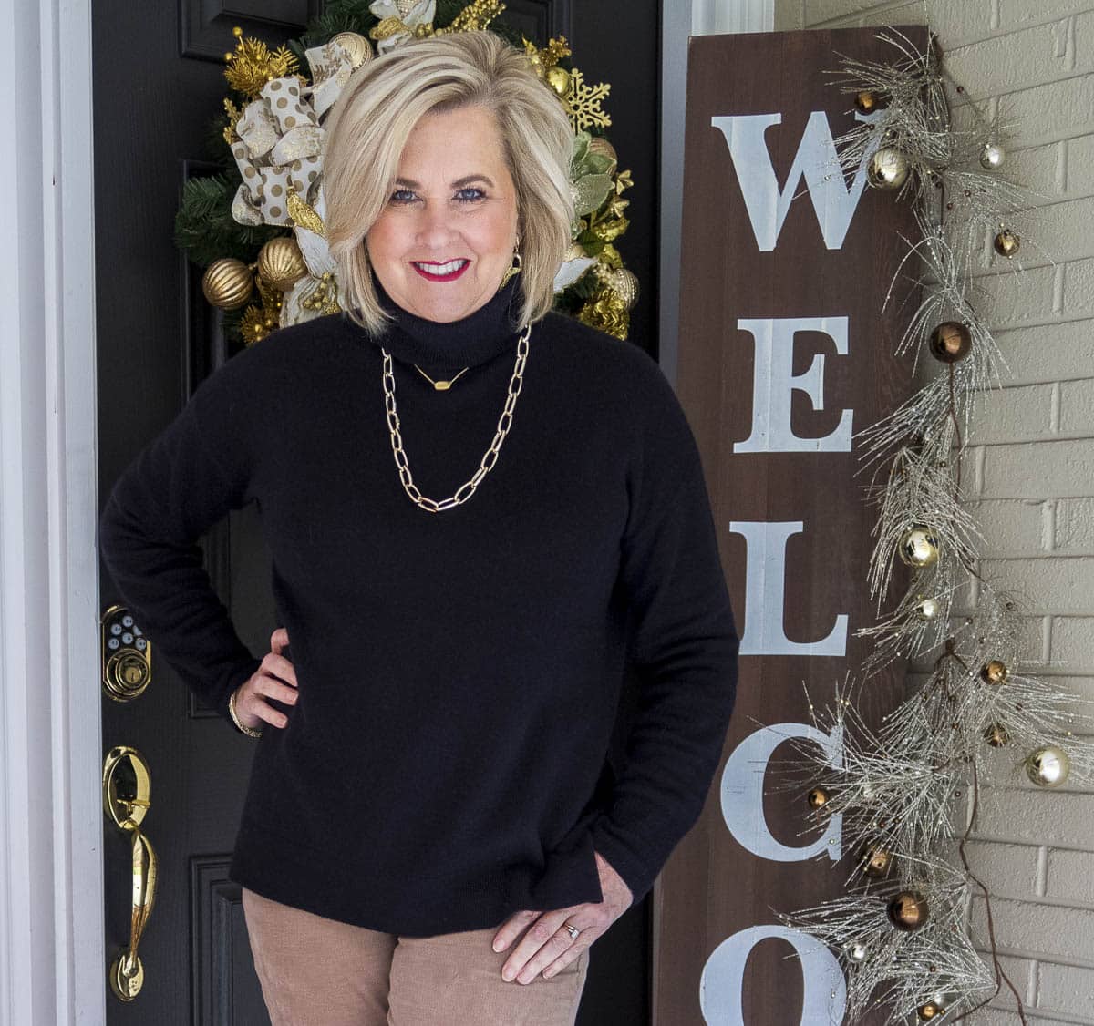 Fashion Blogger 50 Is Not Old is styling a simple black cashmere turtleneck sweater and gold jewelry