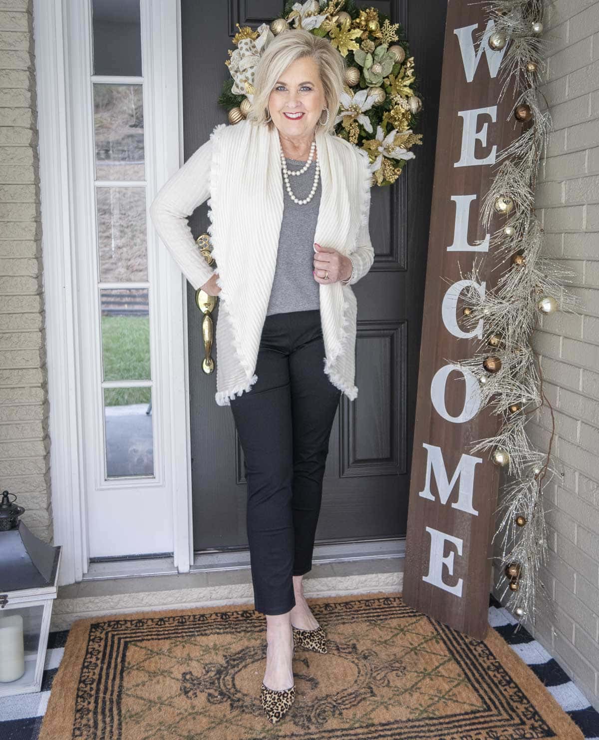 Fashion Blogger 50 Is Not Old is wearing a gray tank with an Ecru colored cocoon cardigan with a large collar, black girlfriend jeans, and leopard print pumps