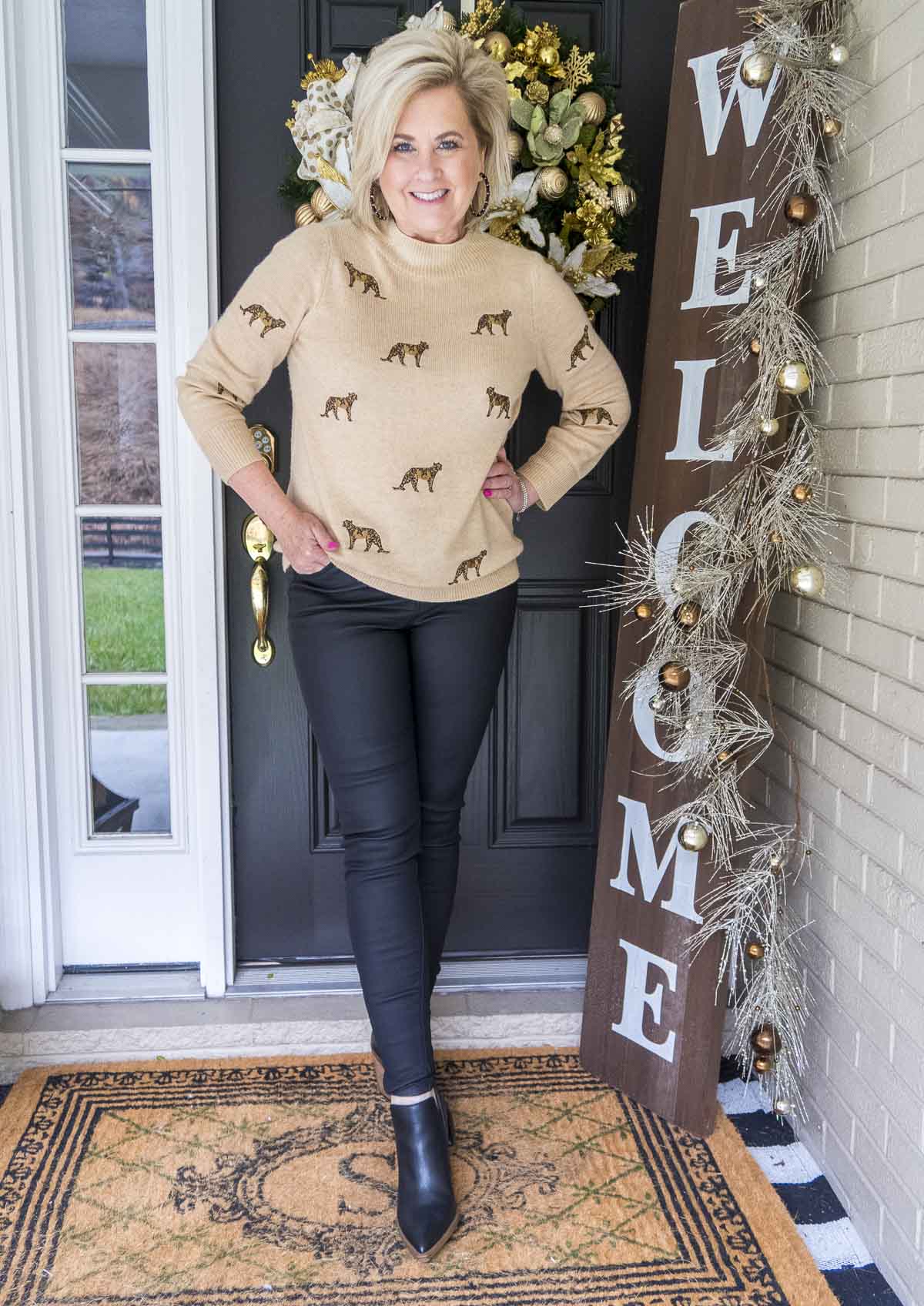 Fashion Blogger 50 Is Not Old is wearing a luxurious cashmere sweater with cheetahs embroidered on it, and a pair of black jeans