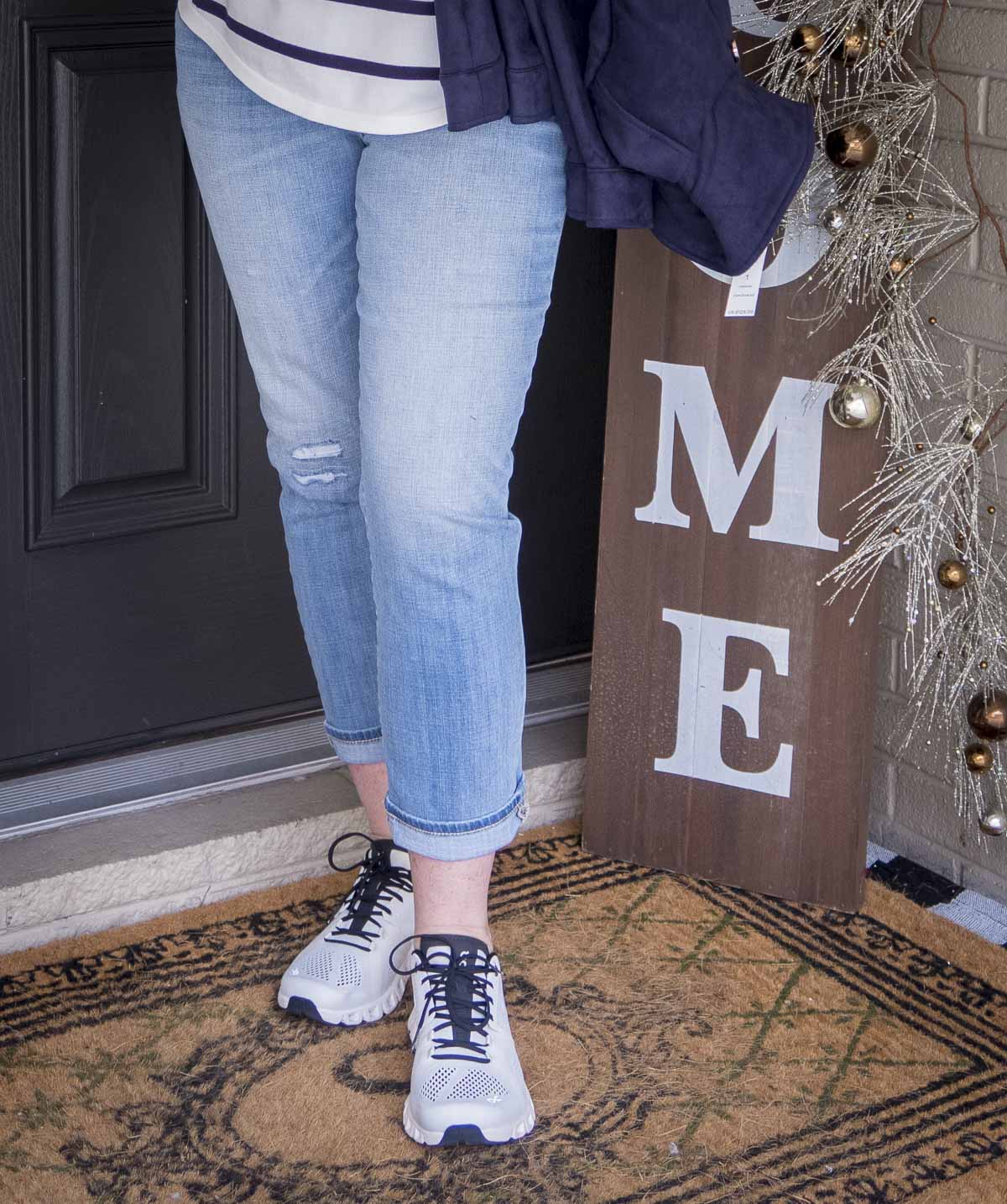 Fashion Blogger 50 Is Not Old is wearing light wash jeans and On Cloud sneakers