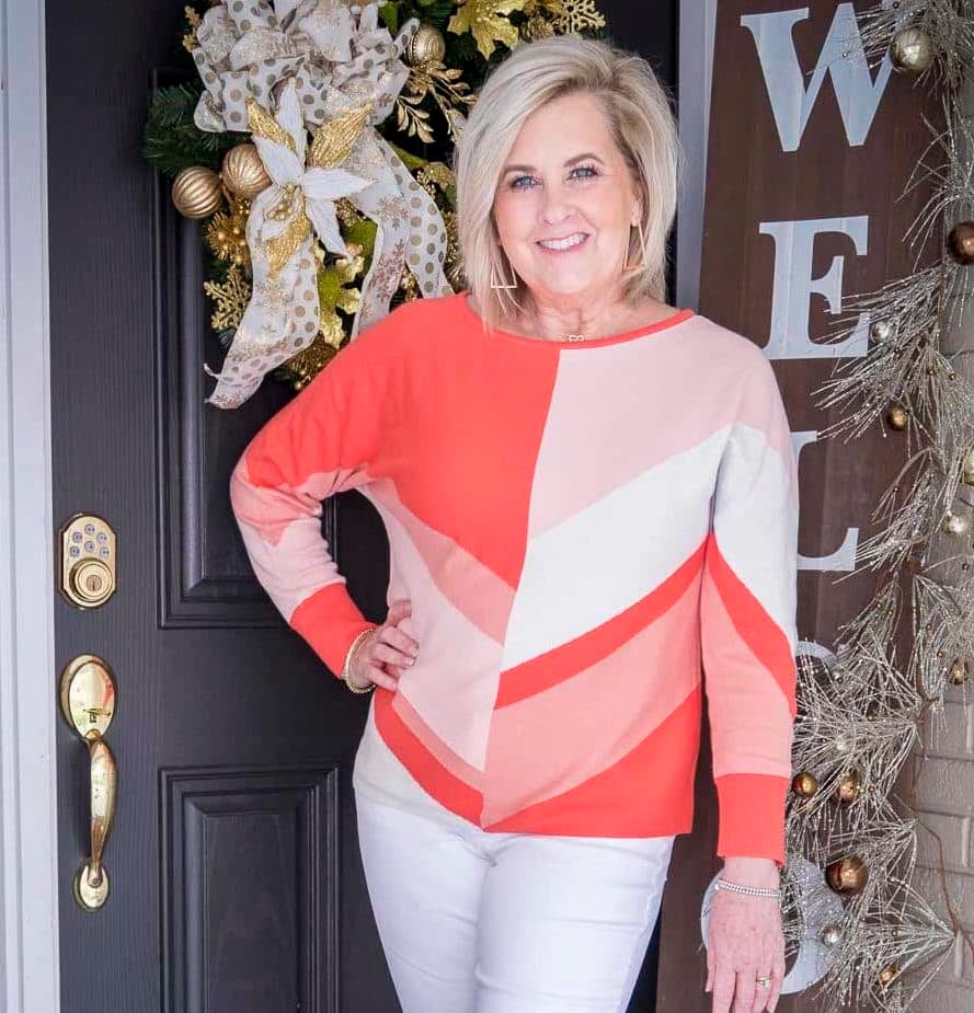 Fashion Blogger 50 Is Not Old is wearing a coral colorblock sweater