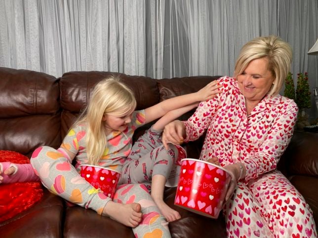 Fashion Blogger 50 Is Not Old is playing with her grandchildren in their PJs and eating popcorn from the Popcorn Factory