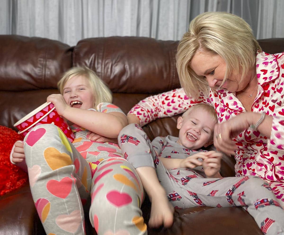 Fashion Blogger 50 Is Not Old is tickling her grandchildren in their PJs