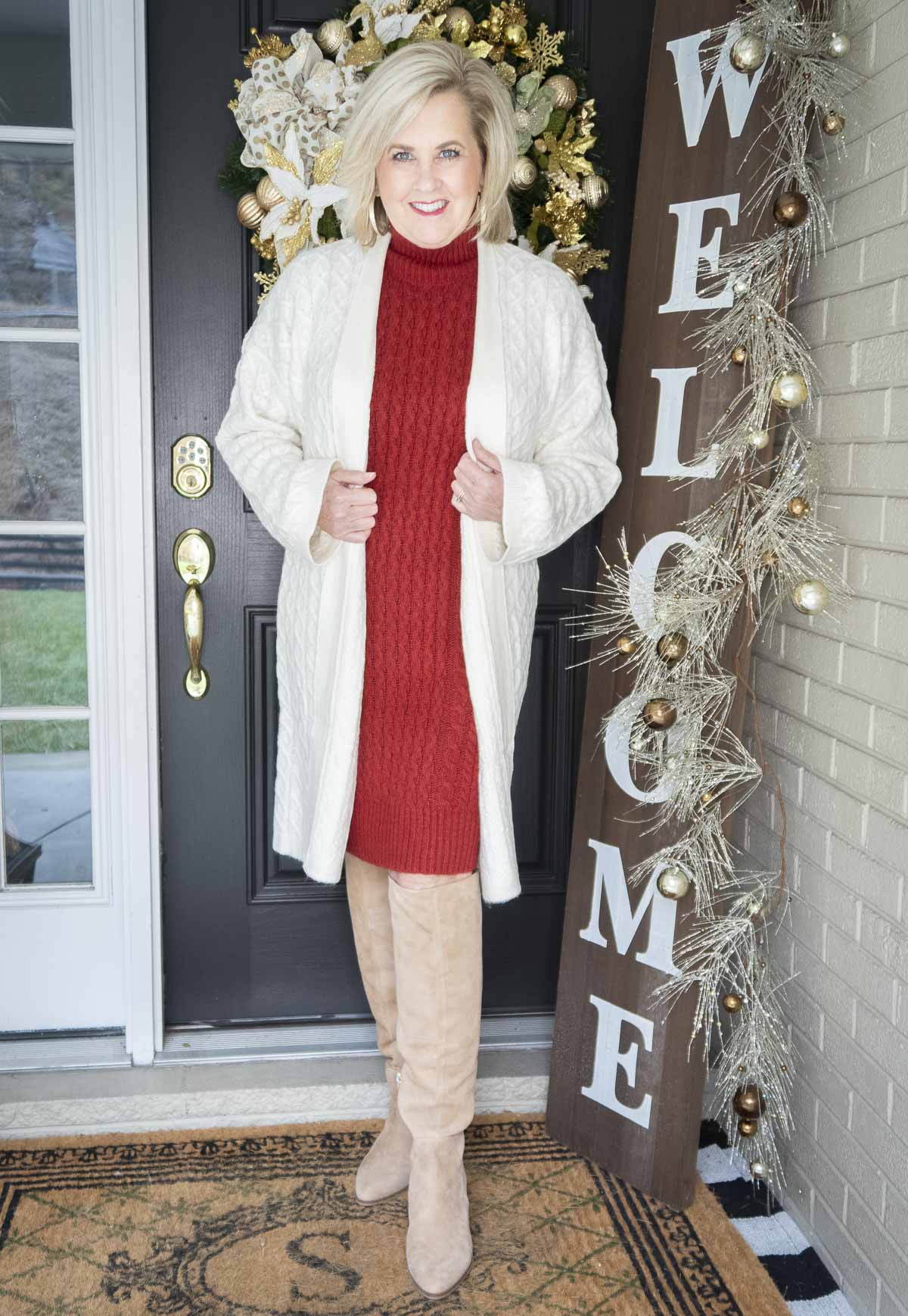 Fashion Blogger 50 Is Not Old is wearing a red sweater dress and a long white cardigan from Ann Taylor, and tall knee boots