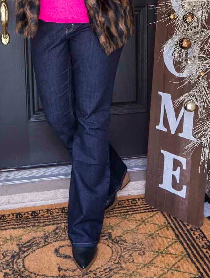 Over 40 Fashion Blogger 50 Is Not Old is wearing flare jeans, and black pointy toe boots