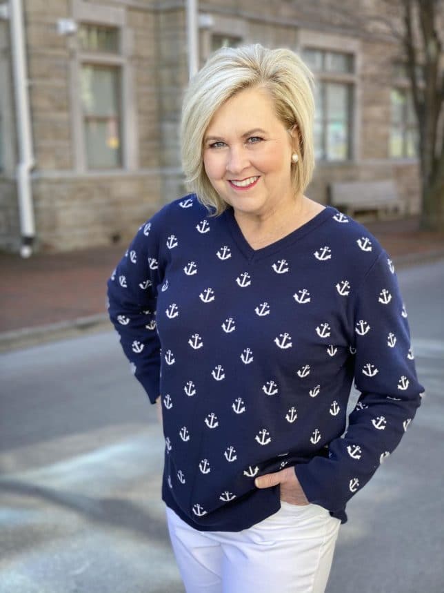 Fashion Blogger 50 Is Not Old is looking stylish in this navy sweaters with white anchors