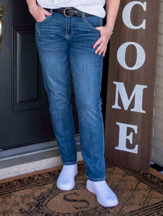 Fashion Blogger 50 Is Not Old is wearing straight leg jeans with white slip-on sneakers