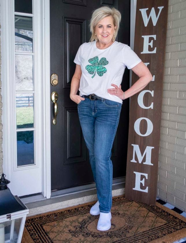 Fashion Blogger 50 Is Not Old is wearing a metallic four leaf clover t-shirt with straight leg jeans