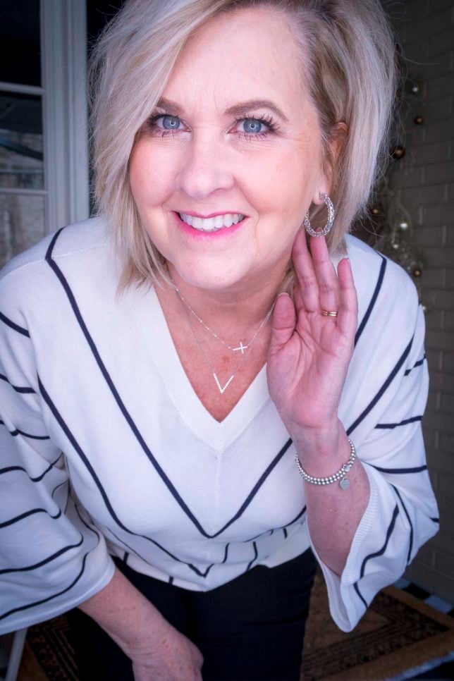 Fashion Blogger 50 Is Not Old is wearing a chevron striped sweater and silver jewelry