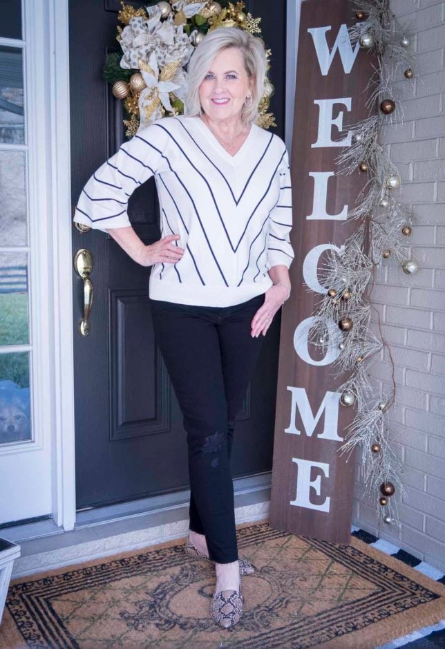 Fashion Blogger 50 Is Not Old is wearing a chevron striped sweater and distressed black jeans