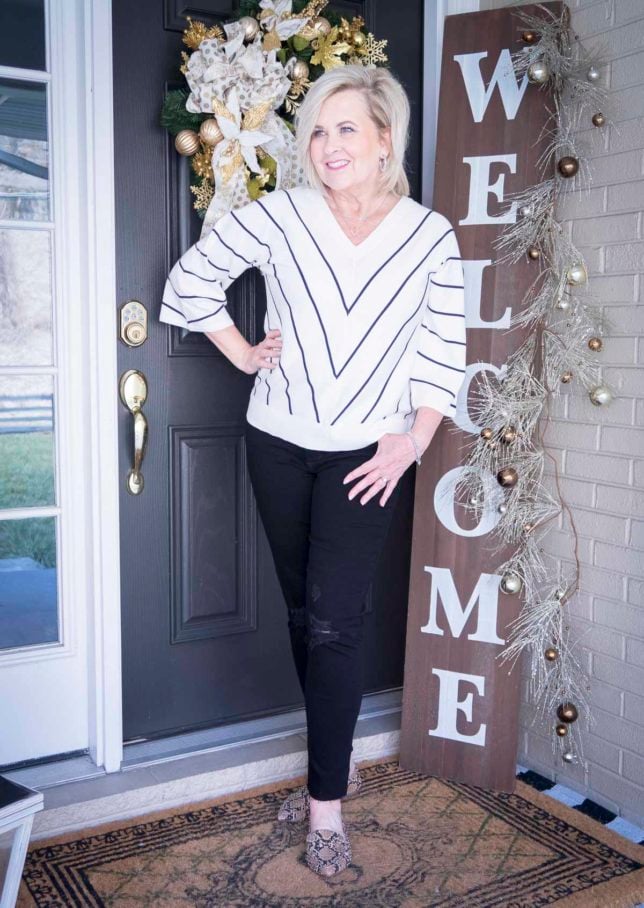Fashion Blogger 50 Is Not Old is looking thin in this chevron striped sweater and distressed black jeans