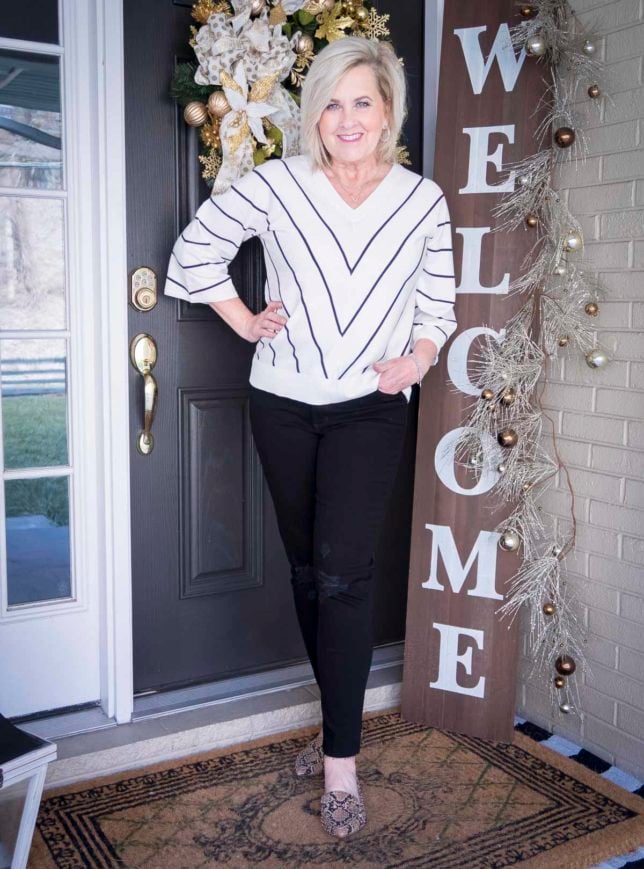 Fashion Blogger 50 Is Not Old is looking thin in this chevron striped top and distressed black jeans