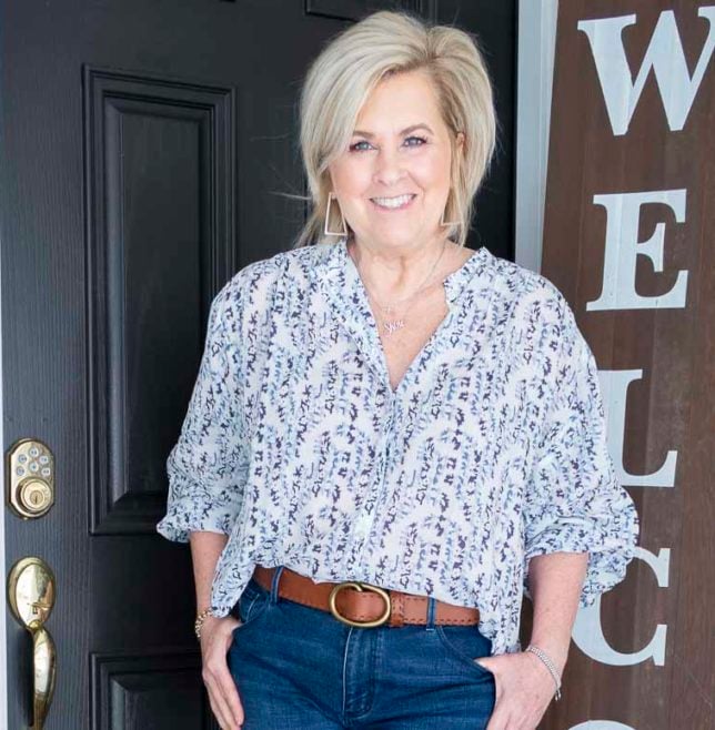 Fashion Blogger 50 Is Not Old is wearing a white blouse with a blue floral vine pattern