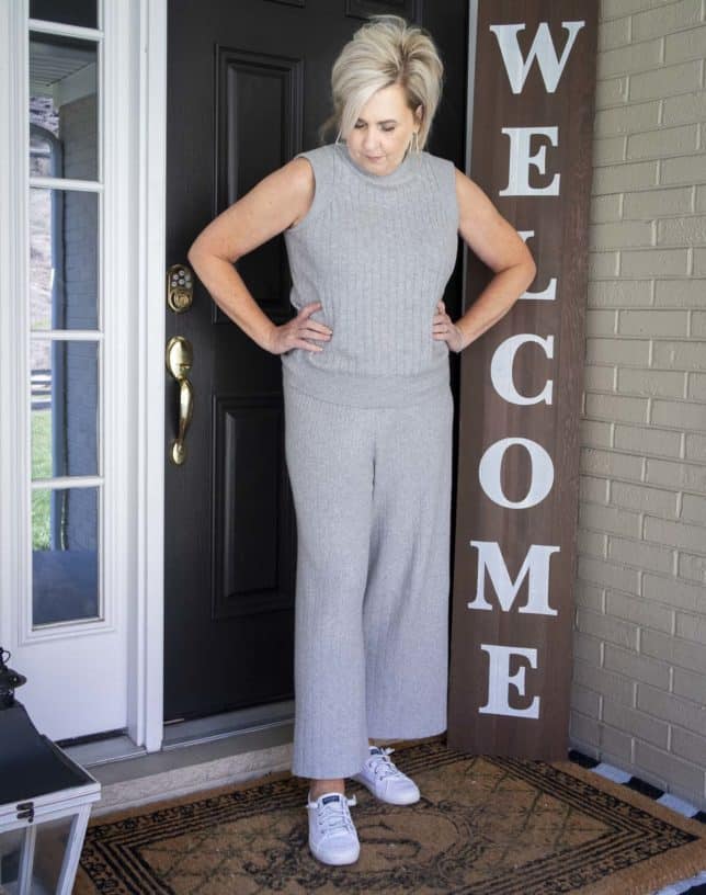 Fashion Blogger 50 Is Not Old is wearing a gray cropped loungewear set with Sperry sneakers