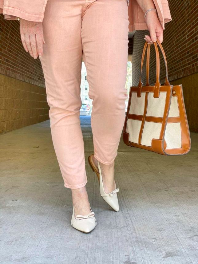 Fashion Blogger 50 Is Not Old is wearing a pair of blush jeggings and carrying a Tory Burch tote 