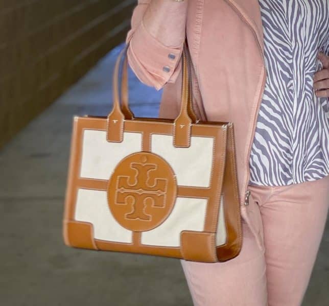 Fashion Blogger 50 Is Not Old is carrying a Tory Burch tote 