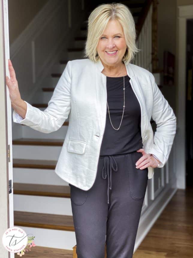 Fashion Blogger 50 Is Not Old is wearing a one and done jumpsuit with a white notched collar blazer