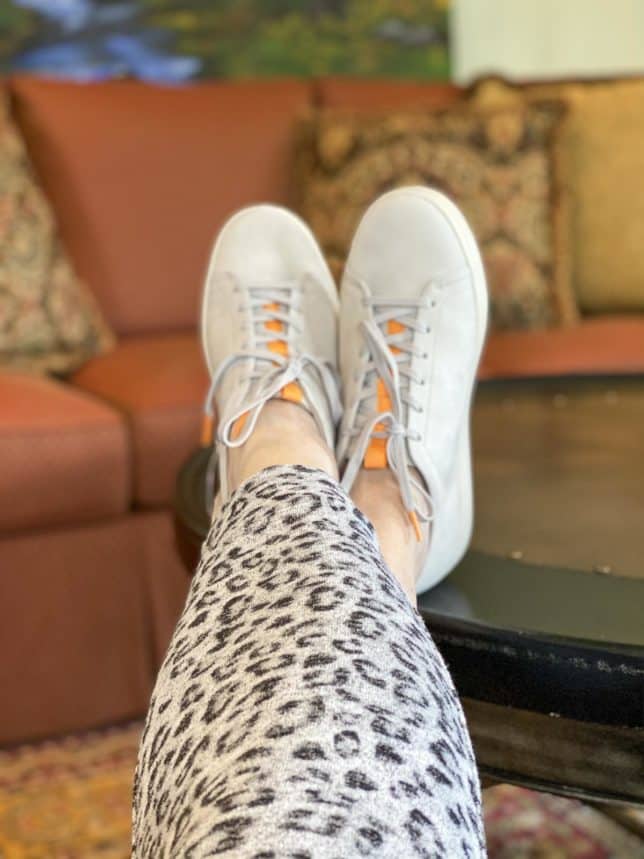 Fashion Blogger 50 Is Not Old is wearing a pair of Vionic gray sneakers with orange accents for summer