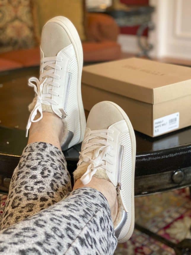 Fashion Blogger 50 Is Not Old is wearing Steve Madden white sneakers with zippers and faux fur