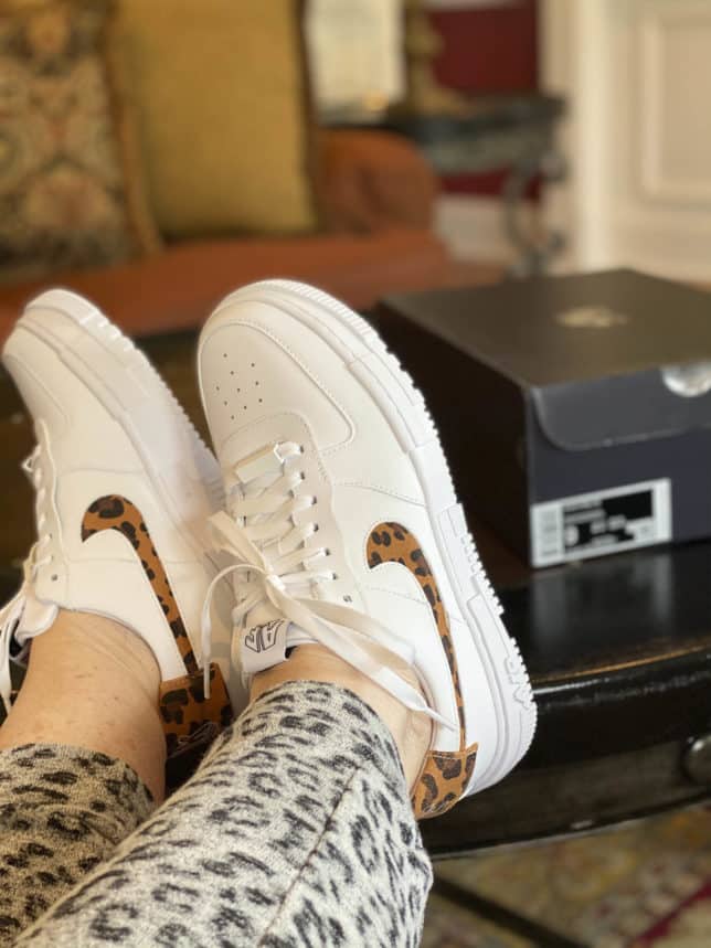 Fashion Blogger 50 Is Not Old is wearing Nike Air Force 1 white sneakers with leopard print for summer