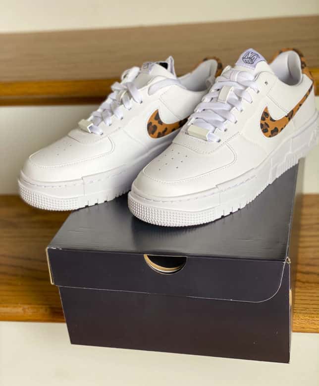 Fashion Blogger 50 Is Not Old is trying on white sneakers with leopard print for summer