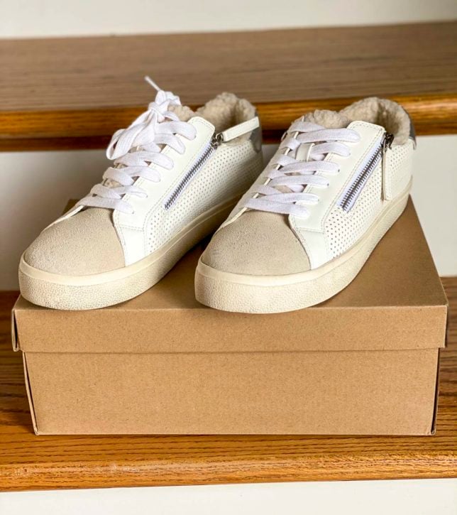 Fashion Blogger 50 Is Not Old is trying on Steve Madden white sneakers with faux fur for summer