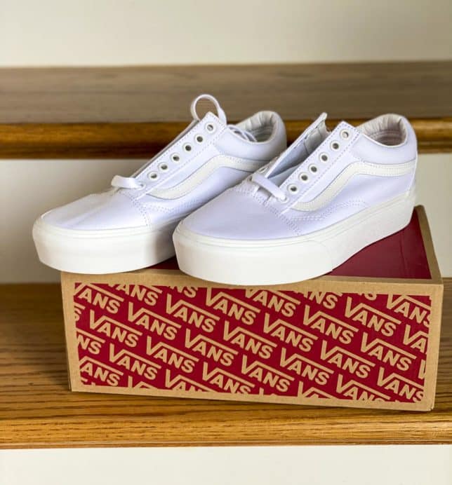 Fashion Blogger 50 Is Not Old is trying on a pair of Vans white sneakers for summer