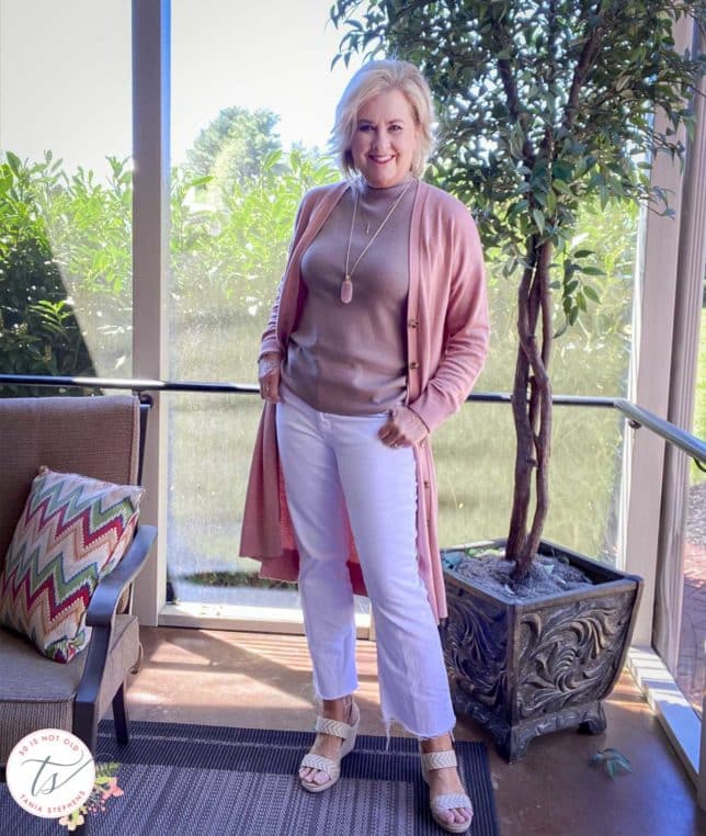 Fashion Blogger 50 Is Not Old is wearing a rose duster, a taupe shell, white cropped pants, and espadrilles