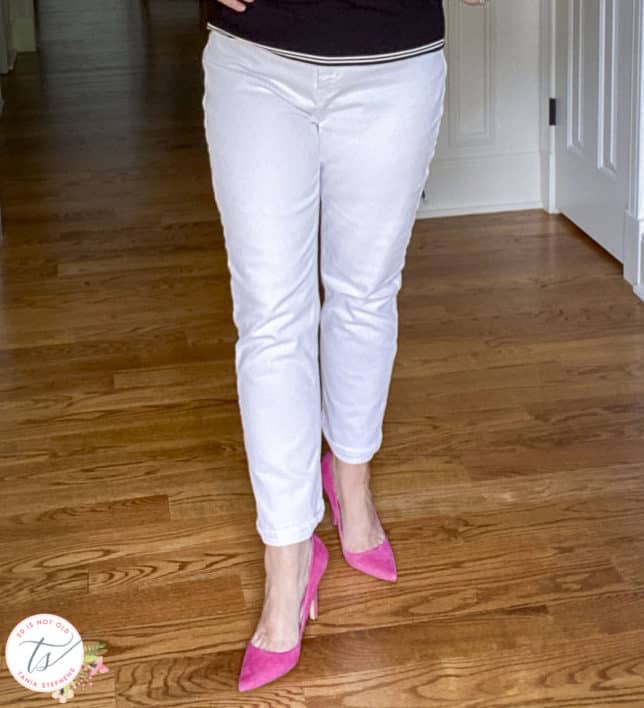 Fashion Blogger 50 Is Not Old is wearing white straight-leg jeans and bright pink suede pumps