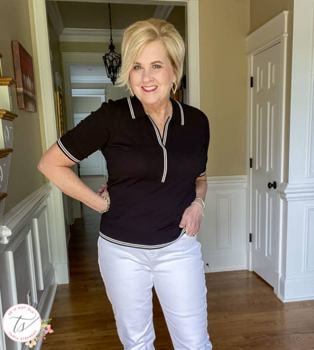 Fashion Blogger 50 Is Not Old is wearing a black sweater with a collar and white edging