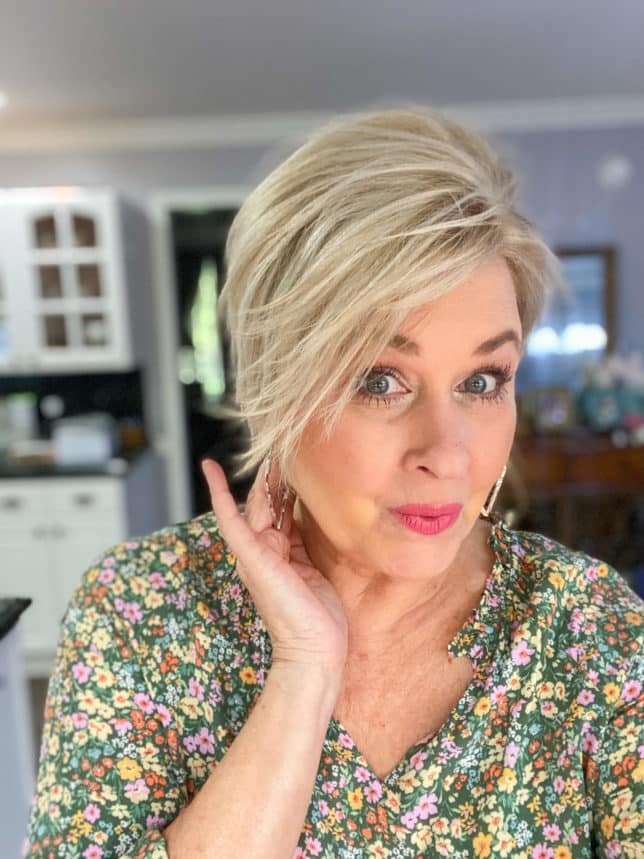 Fashion Blogger 50 Is Not Old is showing her short haircut with silver earrings