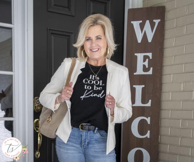 Fashion Blogger 50 Is Not Old is showing a black and white graphic t-shirt with a white blazer