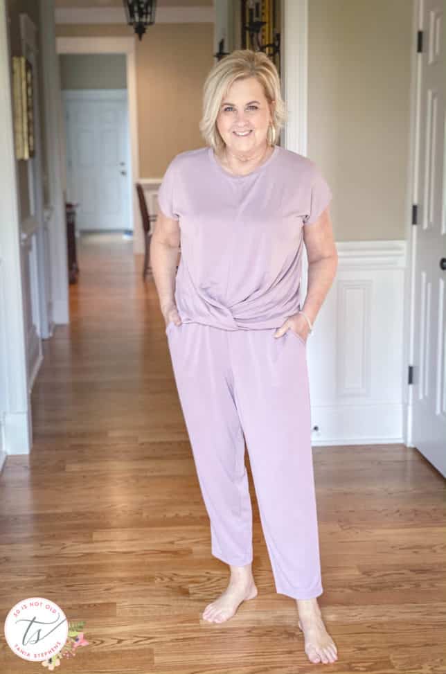 Fashion Blogger 50 Is Not Old is wearing a front twist top and cropped pants in light grape