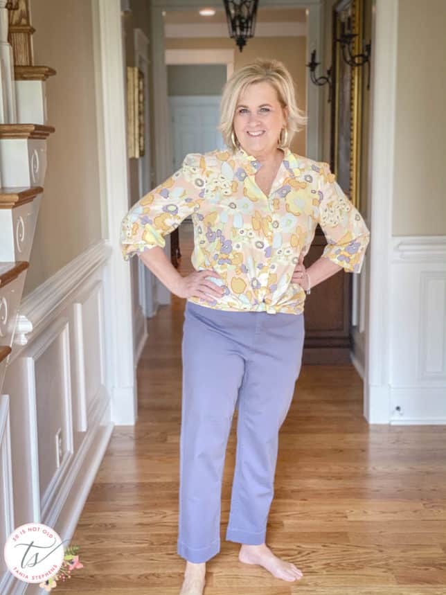 Fashion Blogger 50 Is Not Old is wearing a pretty floral print button-up shirt and a pair of cropped pants in gray