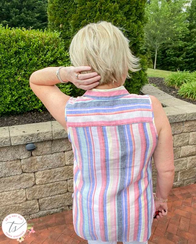 Fashion Blogger 50 Is Not Old is showing the back of a 100% linen striped tunic top from Chico's