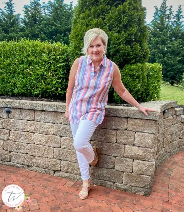 Fashion Blogger 50 Is Not Old will keep cool this Memorial Day in a 100% linen striped tunic top and white straight leg jeans