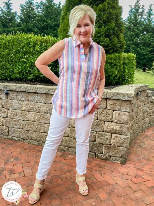 Fashion Blogger 50 Is Not Old will be cool this Memorial Day in a linen striped tunic top and white straight leg jeans