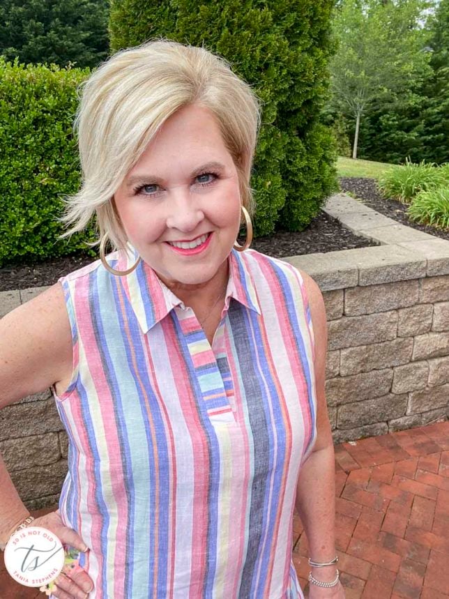 Fashion Blogger 50 Is Not Old is wearing a striped tunic top for Memorial Day