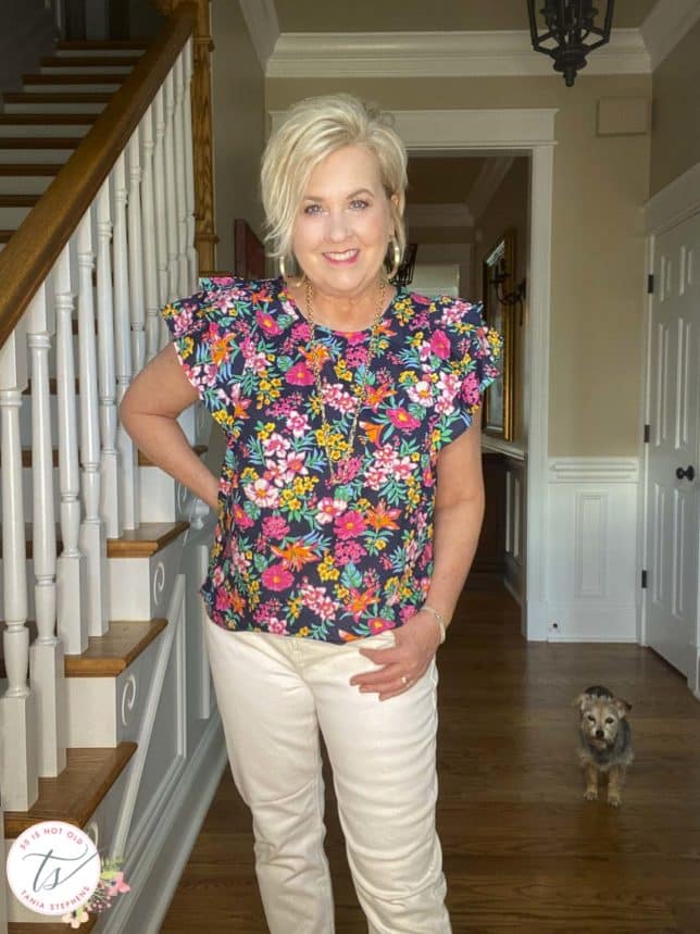 Fashion Blogger 50 Is Not Old is wearing a colorful floral top with ruffled sleeves from J Crew