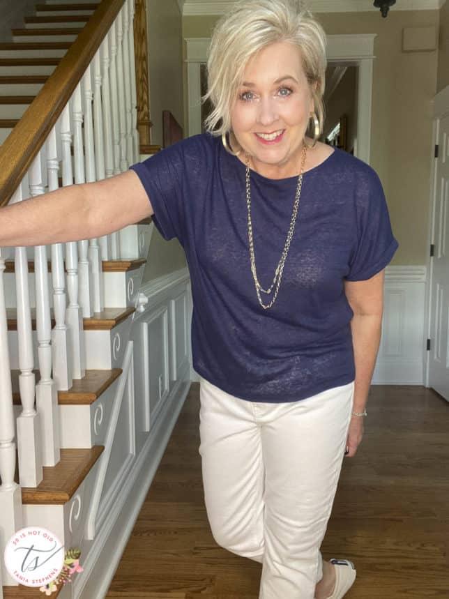 Fashion Blogger 50 Is Not Old is wearing a navy linen-blend top with white jeans