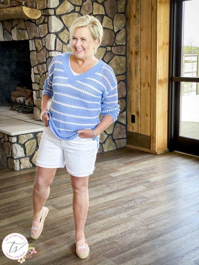Fashion Blogger 50 Is Not Old is wearing a blue and white striped mesh sweater, white denim shorts, and pink espadrilles