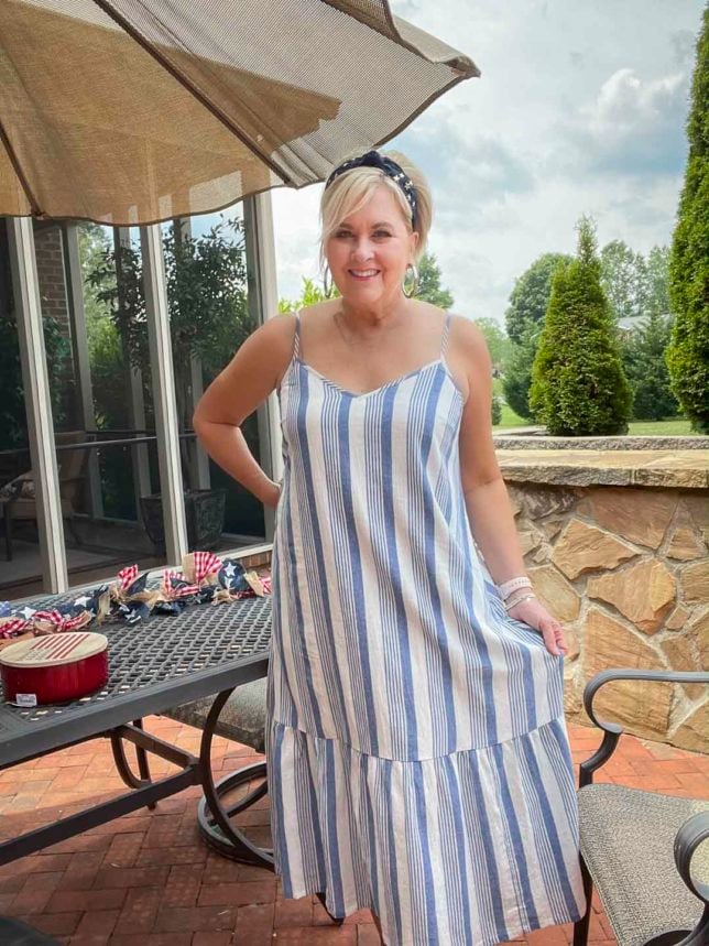 Fashion Blogger 50 Is Not Old is looking festive for the 4th of July in a blue and white striped sundress and a navy headband with stars