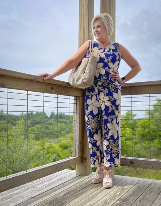 Fashion Blogger 50 Is Not Old is wearing a big, bold blue print sleeveless tank and matching crop pants with espadrille wedge shoes